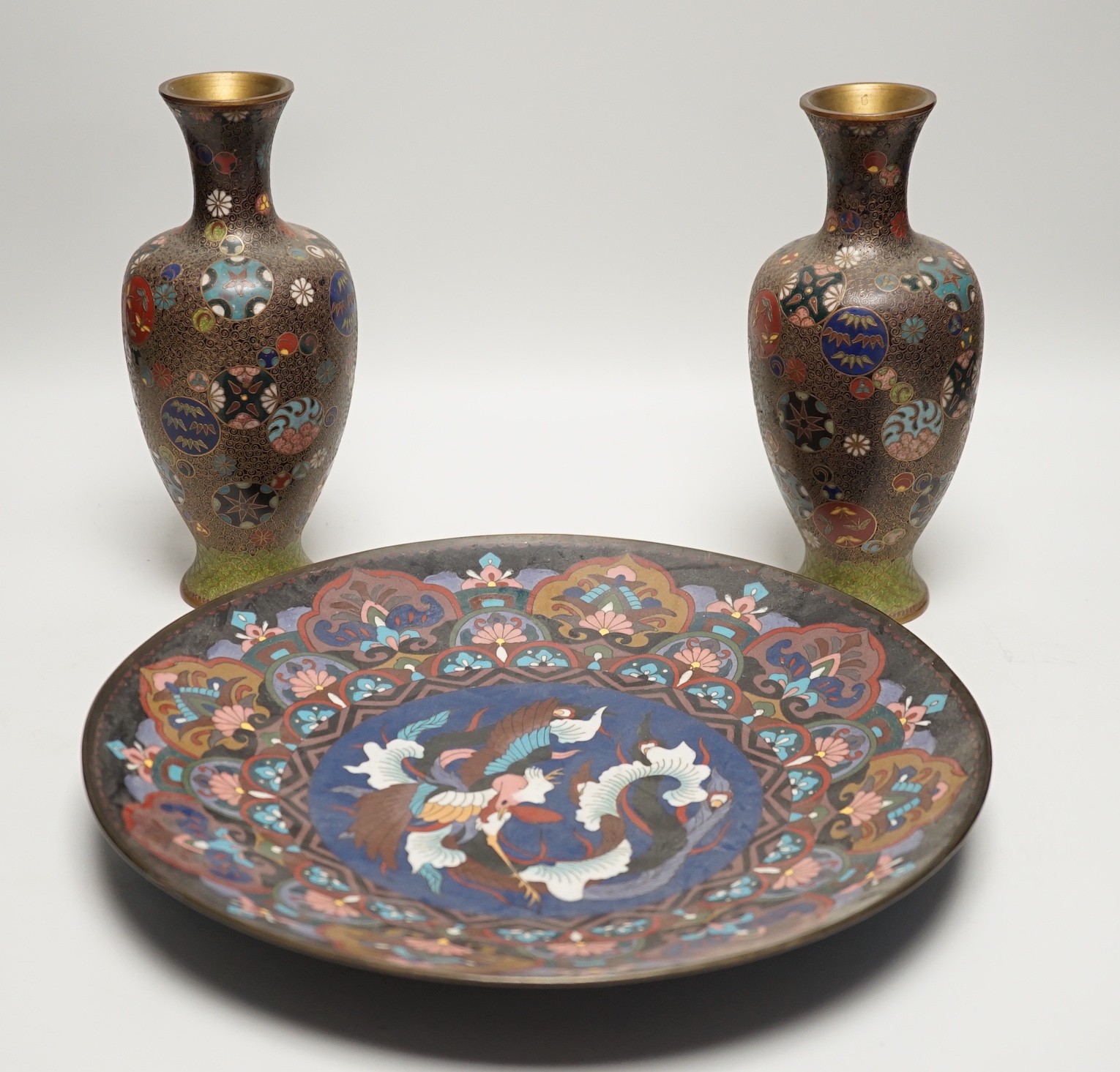 A Japanese cloisonné enamel dish, 30.5cm diameter and a pair of Japanese cloisonné enamel vases. (3)